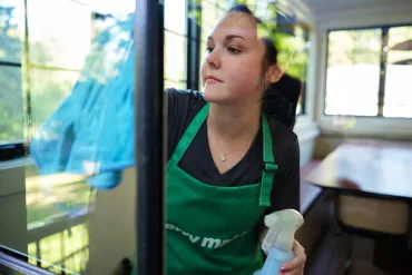 merry maid cleaning a window